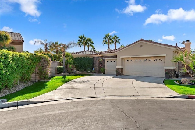 view of front of home featuring a garage and a front lawn