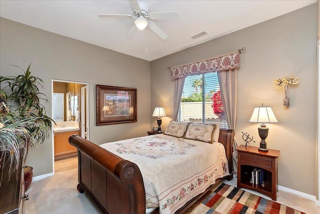 carpeted bedroom featuring ceiling fan and ensuite bath