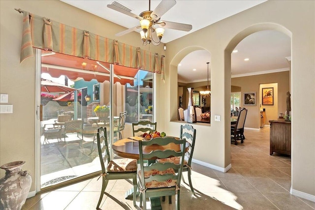 dining room featuring ceiling fan, ornamental molding, and tile patterned floors