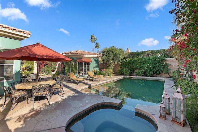 view of pool with an in ground hot tub and a patio