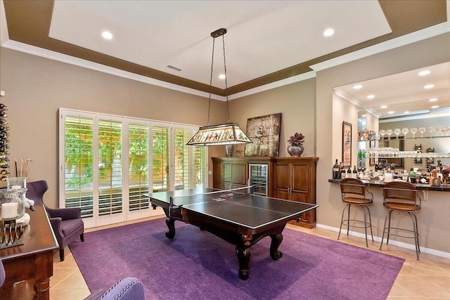 recreation room with bar, ornamental molding, and light tile patterned floors