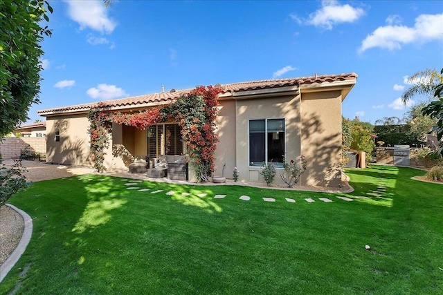 rear view of property featuring a yard and a patio area