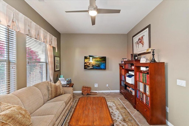 living room with ceiling fan and light tile patterned floors