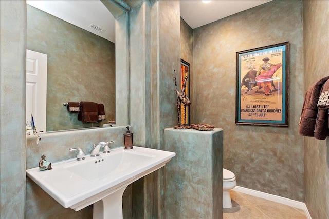 bathroom featuring sink, tile patterned floors, and toilet