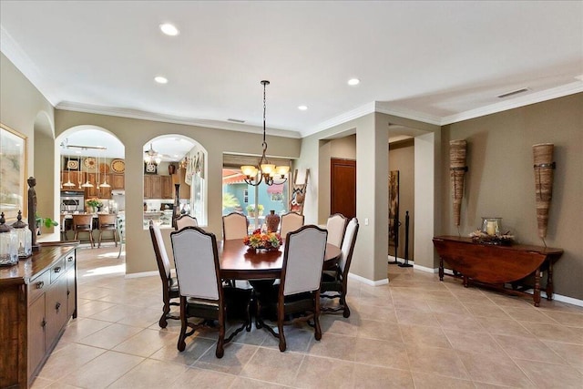 dining space featuring a notable chandelier, crown molding, and light tile patterned floors