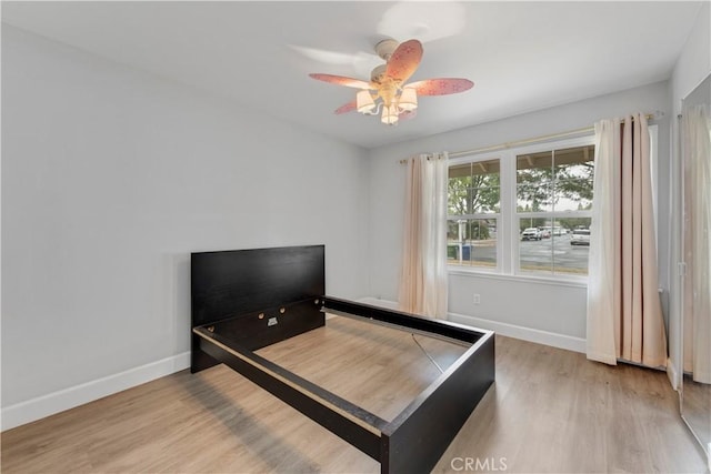 bedroom with ceiling fan and hardwood / wood-style flooring