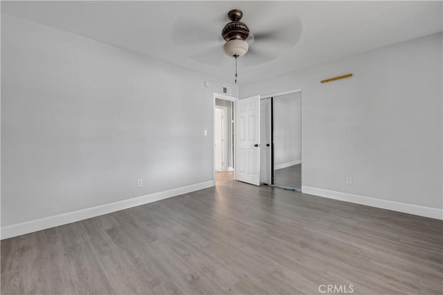 unfurnished room with ceiling fan and hardwood / wood-style floors