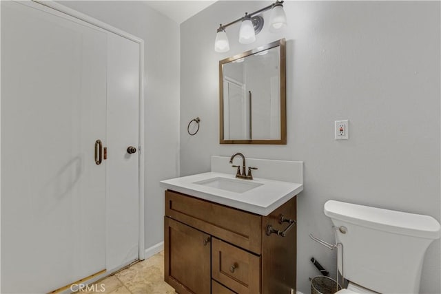 bathroom featuring toilet, tile patterned flooring, and vanity