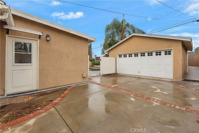 view of home's exterior featuring an outdoor structure and a garage