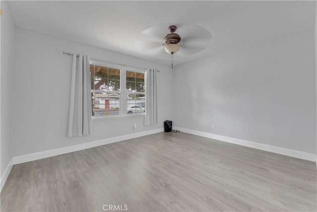 spare room featuring ceiling fan and light hardwood / wood-style flooring