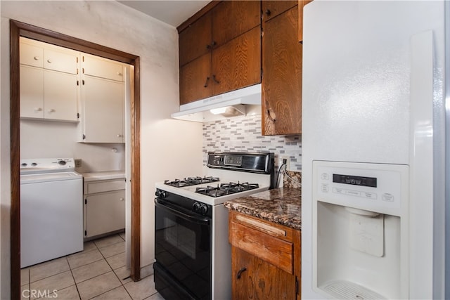 kitchen featuring light tile patterned flooring, gas range, white refrigerator with ice dispenser, white cabinets, and washer / clothes dryer