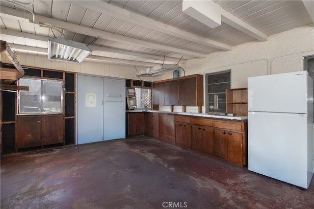 kitchen featuring white fridge and beam ceiling