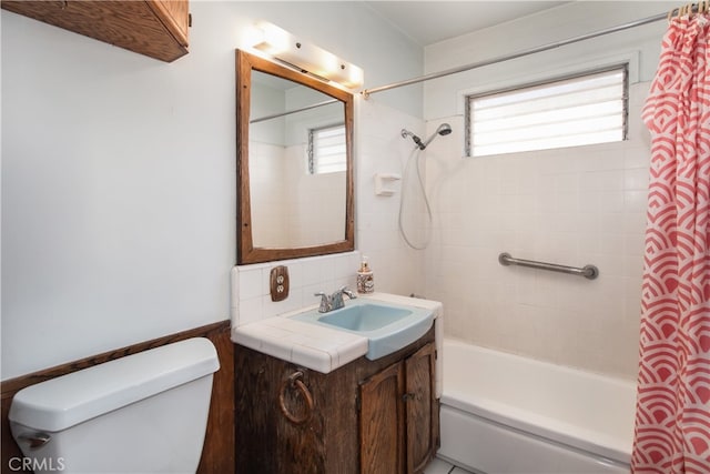 full bathroom with toilet, vanity, and shower / bath combination with curtain