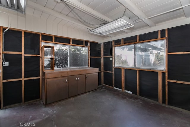 misc room with vaulted ceiling with beams