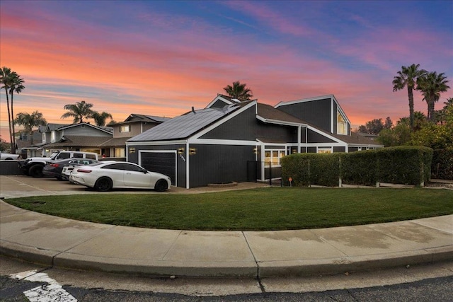 view of front of house with a lawn and a garage