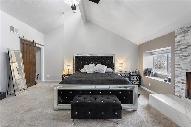 carpeted bedroom with beam ceiling, a fireplace, high vaulted ceiling, and a barn door