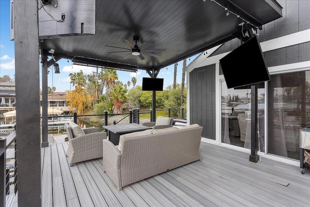 deck with outdoor lounge area and ceiling fan