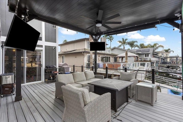 wooden terrace featuring an outdoor hangout area and ceiling fan