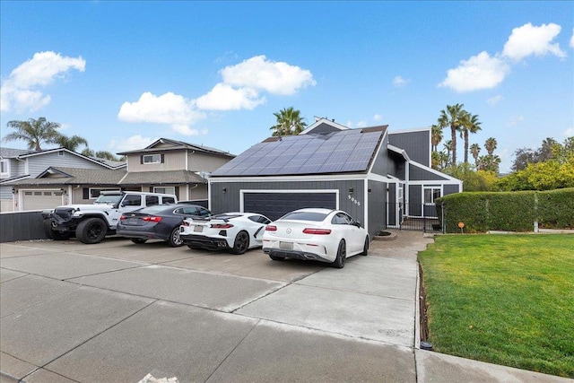 view of front of home featuring a garage, a front lawn, and solar panels