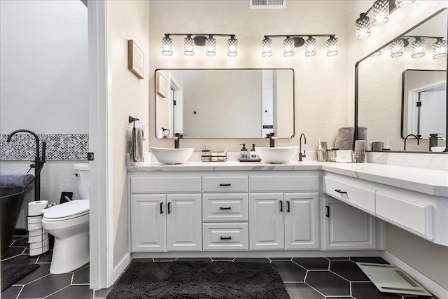 bathroom with tile patterned floors, toilet, and vanity