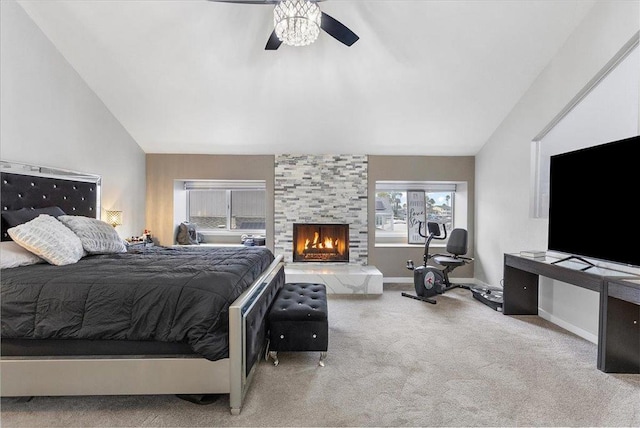 carpeted bedroom with ceiling fan, lofted ceiling, and a fireplace