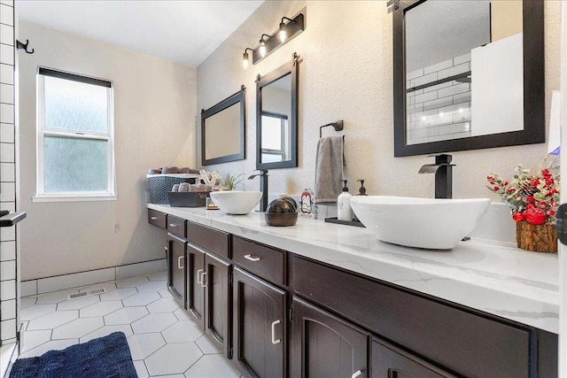 bathroom with tile patterned floors and vanity