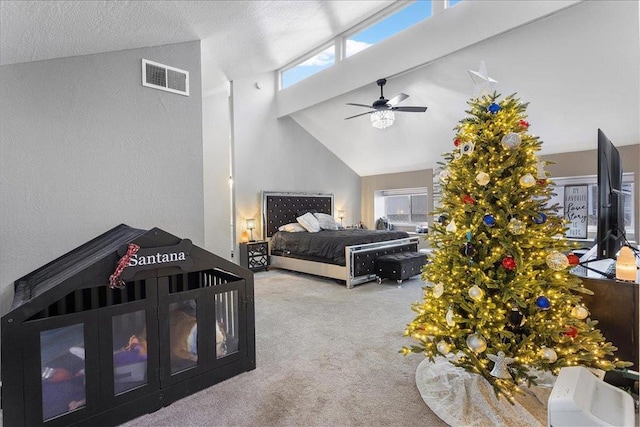 bedroom with multiple windows, high vaulted ceiling, light colored carpet, and ceiling fan