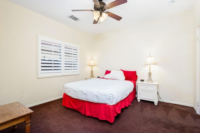 bedroom with ceiling fan and dark colored carpet