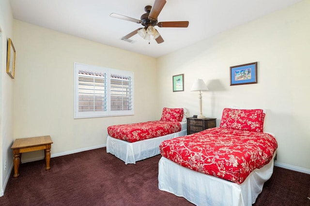 bedroom with ceiling fan and dark carpet