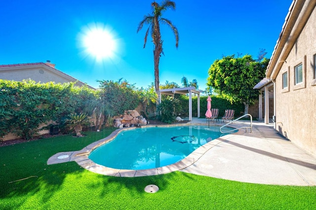 view of pool featuring a lawn and a patio