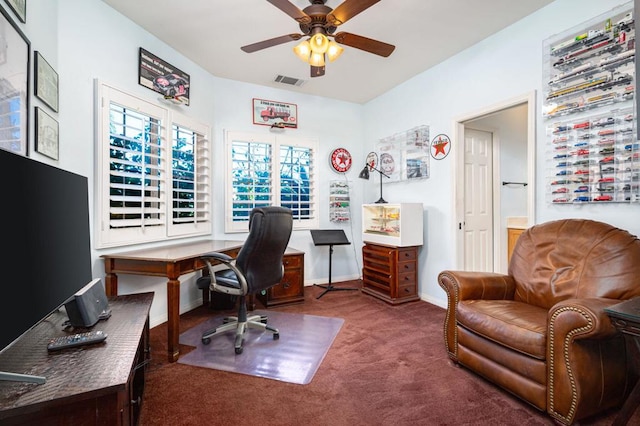 office space featuring ceiling fan and dark colored carpet