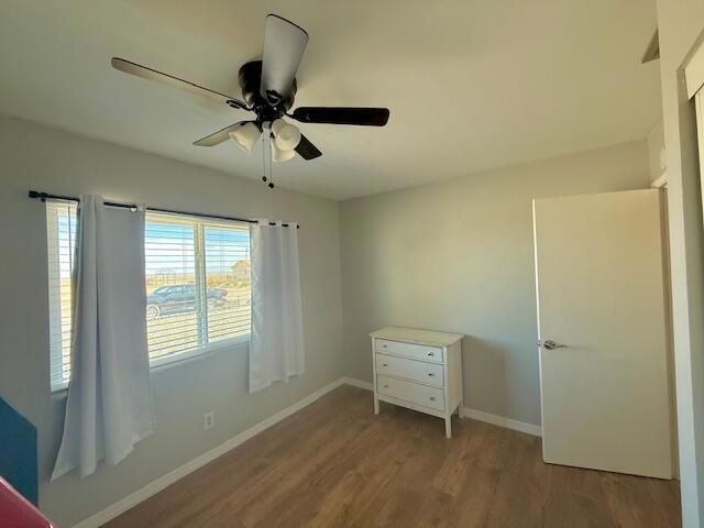 unfurnished bedroom with ceiling fan and light hardwood / wood-style flooring