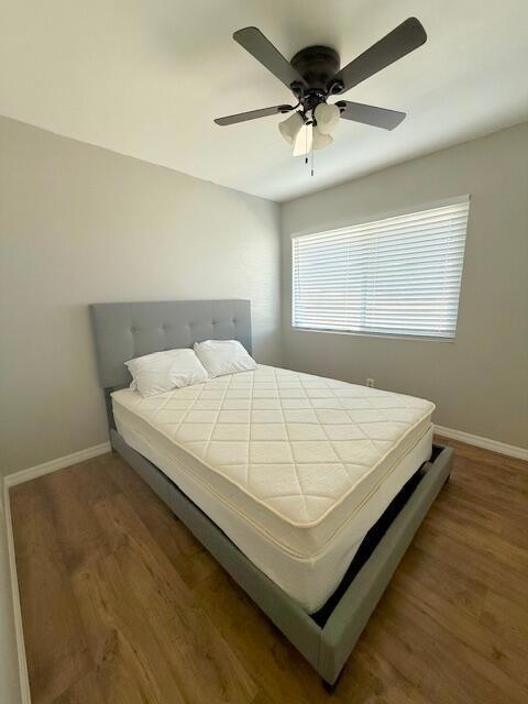 bedroom featuring ceiling fan and dark hardwood / wood-style flooring