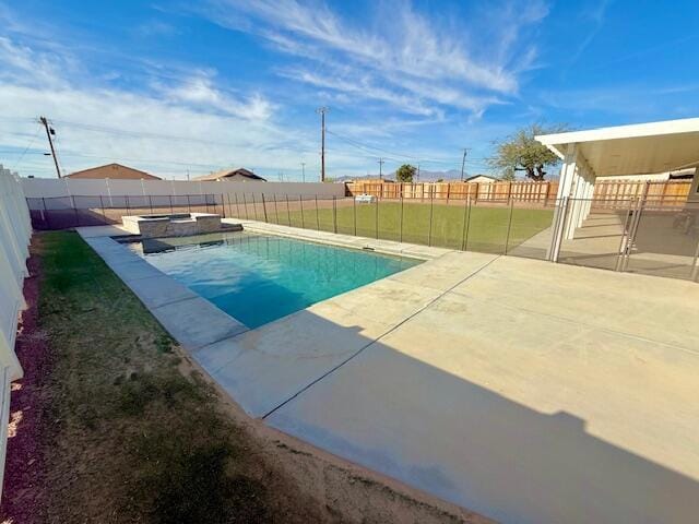 view of pool with a yard and a patio