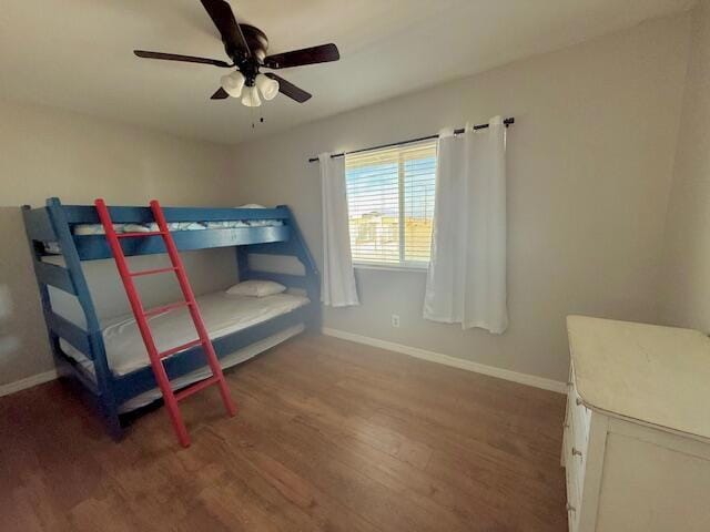 bedroom with ceiling fan and dark hardwood / wood-style flooring