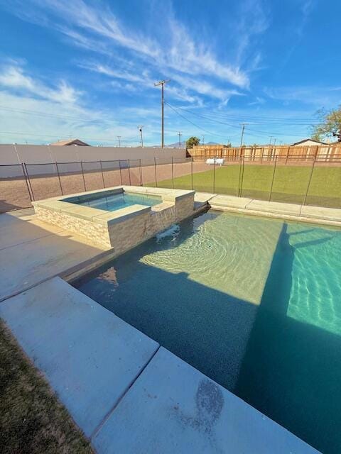 view of pool with an in ground hot tub and a yard