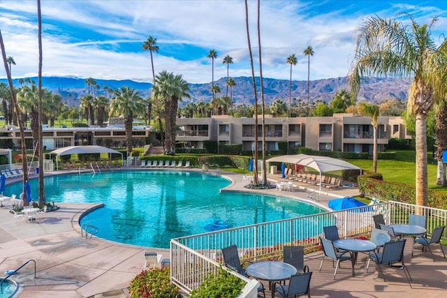 view of pool with a patio area and a mountain view