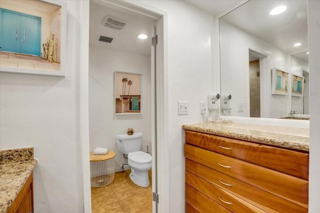 bathroom featuring toilet, vanity, and tile patterned floors