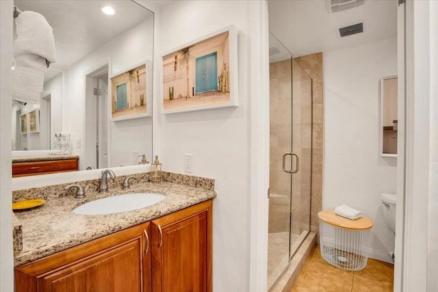 bathroom featuring tile patterned floors, walk in shower, toilet, and vanity