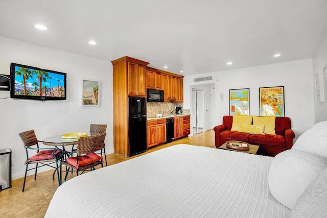 bedroom featuring black fridge