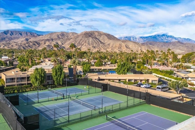 view of tennis court featuring a mountain view