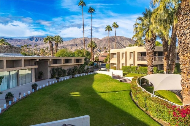 view of home's community with a lawn and a mountain view