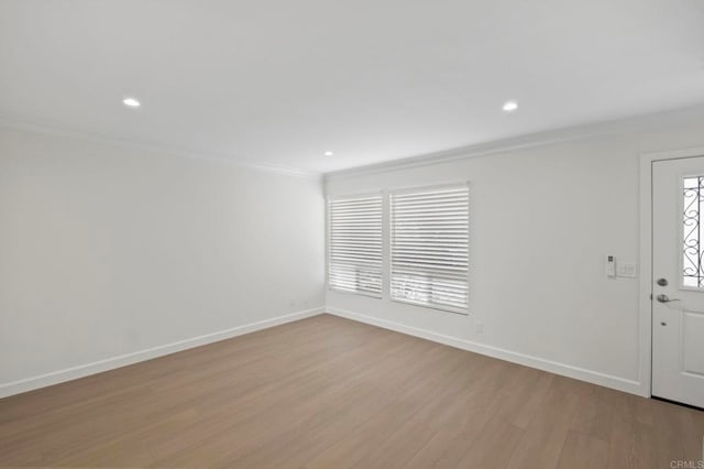 entryway featuring ornamental molding and light hardwood / wood-style flooring