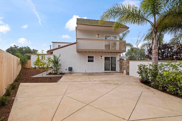 back of house with a balcony and a patio area