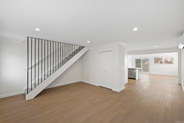 interior space with light wood-type flooring and ornamental molding