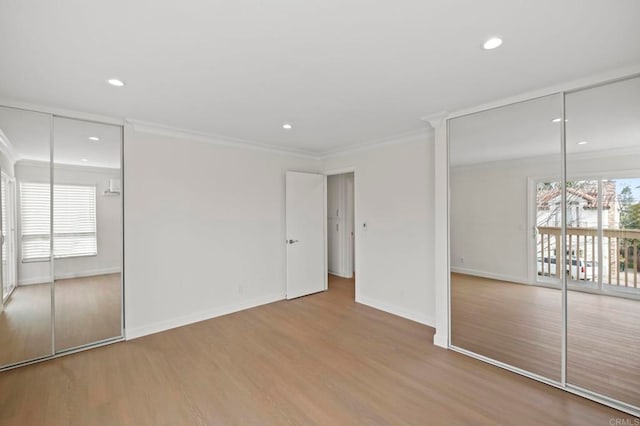 unfurnished bedroom featuring light hardwood / wood-style flooring and ornamental molding