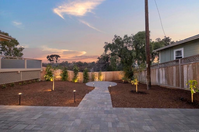 yard at dusk with a patio