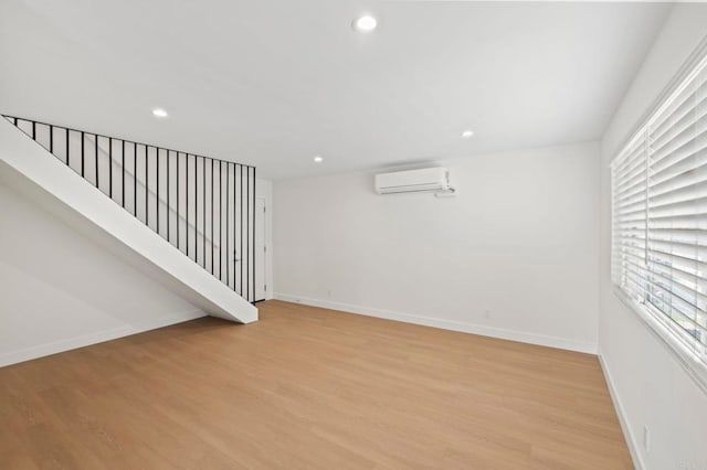 interior space with light hardwood / wood-style floors and a wall mounted air conditioner