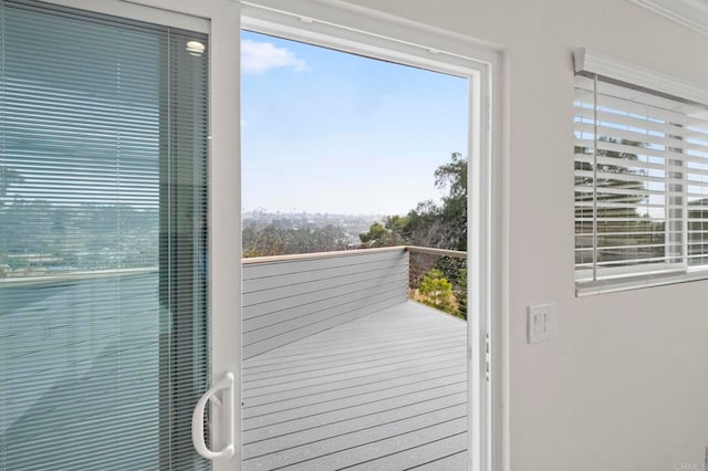 entryway with crown molding and a healthy amount of sunlight