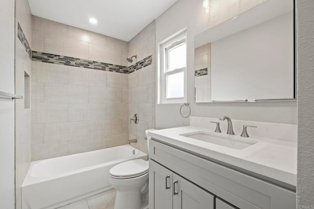 full bathroom featuring toilet, tiled shower / bath combo, tile patterned floors, and vanity